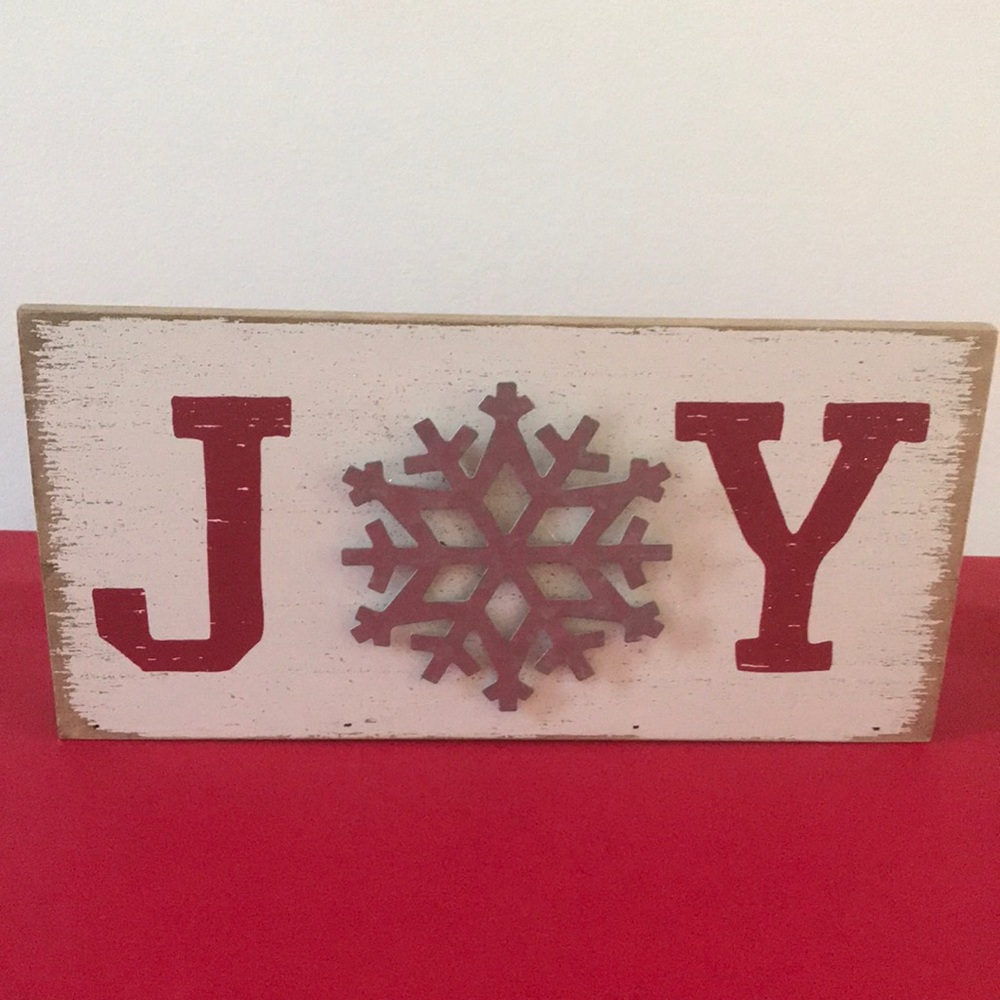 Christmas Holiday JOY wooden rustic sign with snowflake and red lettering.